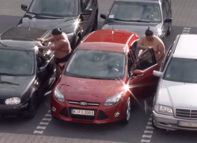 Two Sumo Wrestlers try to get into a Ford Focus